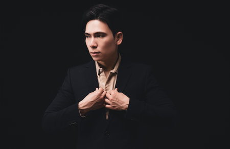 Photo of young Asian businessman on backgroundの写真素材