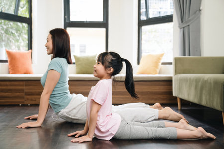 Asian mother and daughter exercise at homeの写真素材