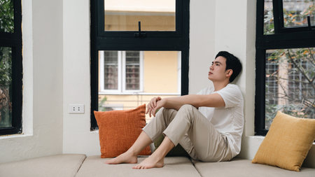 Image of young Asian man at homeの写真素材
