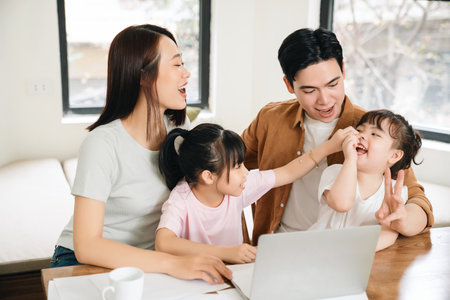 Young Asian family at homeの写真素材