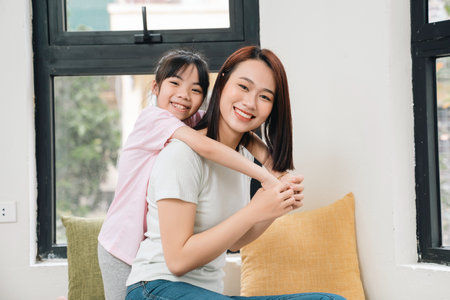 Image of young Asian mother and daughter at homeの写真素材