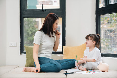 Image of young Asian mother and daughter at homeの写真素材