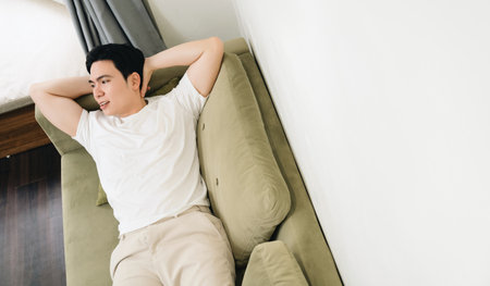 Image of young Asian man at homeの写真素材