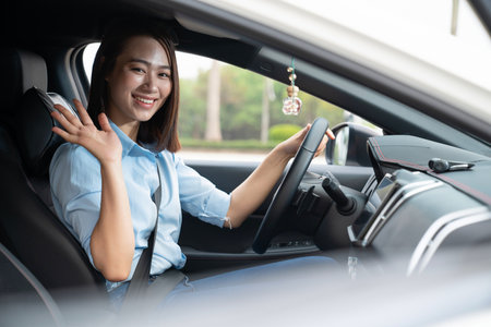 Young Asian woman with carの写真素材