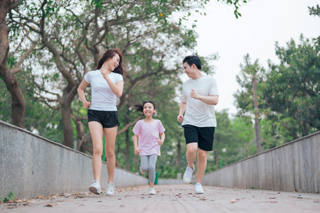 photo of young Asian family exercise at parkの写真素材