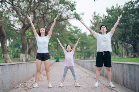photo of young Asian family exercise at parkの写真素材