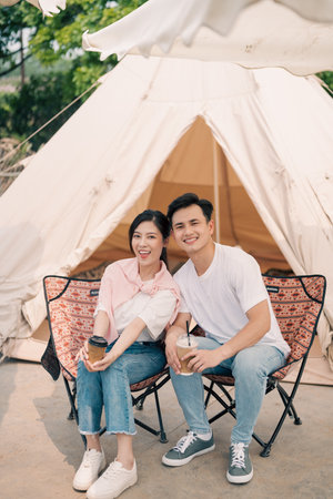 Young Asian couple camping outsideの写真素材