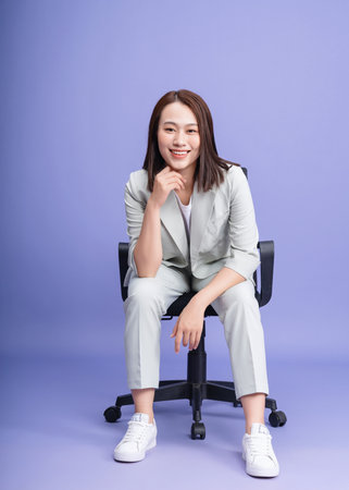 Photo of young Asian businesswoman on backgroundの写真素材