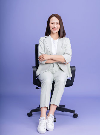 Photo of young Asian businesswoman on backgroundの写真素材
