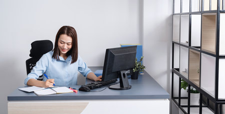 Photo of young Asian businesswoman working at officeの写真素材