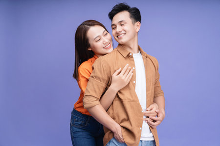 Photo of young Asian couple on backgroundの写真素材