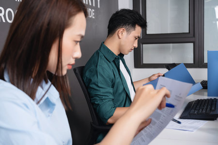 Photo of two young Asian business person working at officeの写真素材