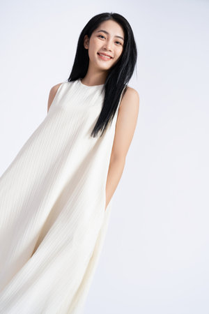 Photo of young Asian girl wearing dress on backgroundの写真素材