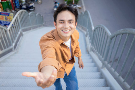 Portrait of young Asian man outsideの写真素材