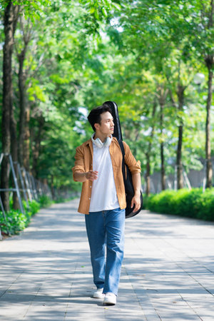 Portrait of young Asian man outsideの写真素材