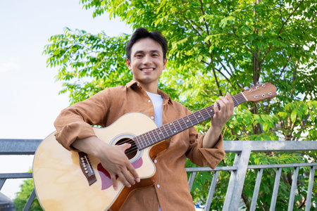 Portrait of young Asian man outsideの写真素材