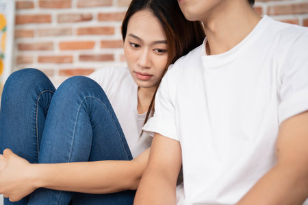Photo of young Asian couple at homeの写真素材