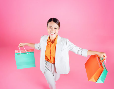 Photo of young Asian businesswoman on backgroundの写真素材