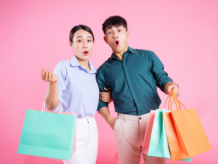 Photo of young Asian couple on backgroundの写真素材
