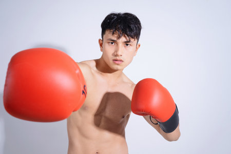 Photo of young Asian boxer on white backgroundの写真素材