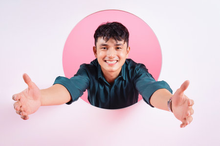 Photo of young Asian man on backgroundの写真素材