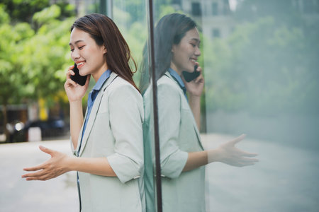 Photo of young Asian businesswoman outdoorの写真素材
