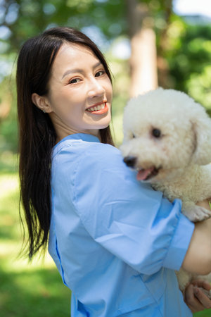 Photo of young Asian girl with her dogの写真素材