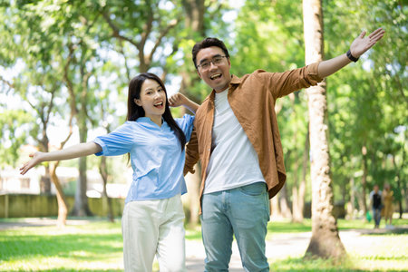 Photo of young Asian couple at parkの写真素材
