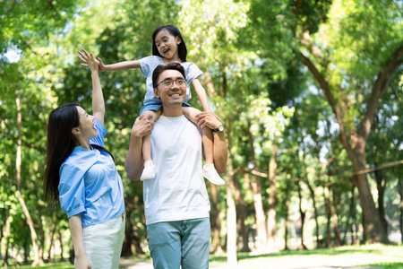 Photo of young Asian family at parkの写真素材