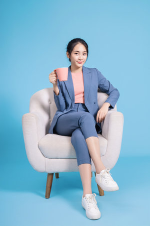 Photo of young Asian businesswoman on backgroundの写真素材