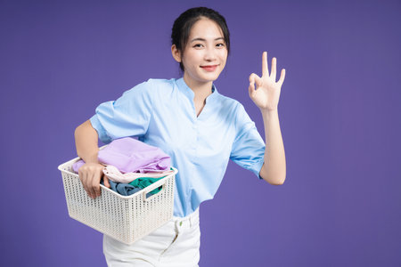 Image of young Asian woman on backgroundの写真素材