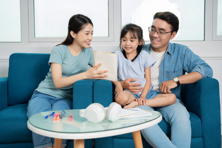 Photo of young Asian family studying together at homeの写真素材