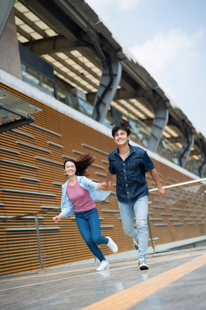 Photo of young Asian couple hang out together