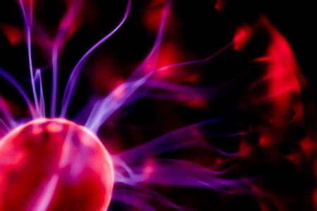 Electricity flashes on a dark background in a gas-discharge flaskの写真素材