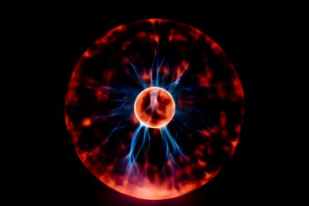 Electricity flashes on a dark background in a gas-discharge flaskの写真素材