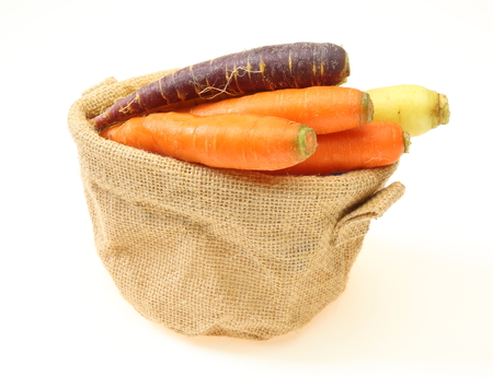 Carrots of various colors in a jute bagの写真素材