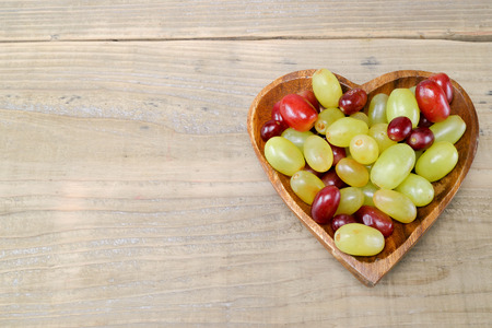 Grapes in a heart shaped plateの写真素材
