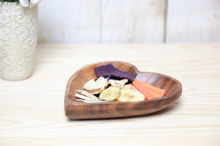 Dried vegetables in a wooden bowlの写真素材