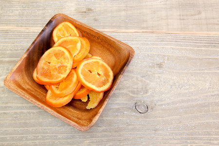 Dried orange in a wooden bowlの写真素材