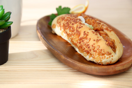 grilled chicken sandwich on a wooden plateの写真素材