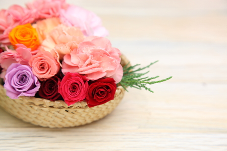 flower basket in a wooden backgroundの写真素材