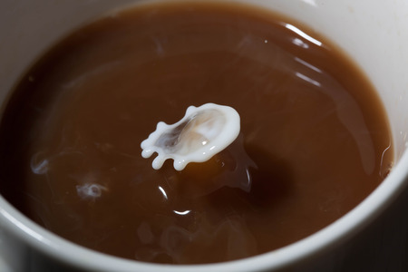 milk splashing in the coffee cupの写真素材