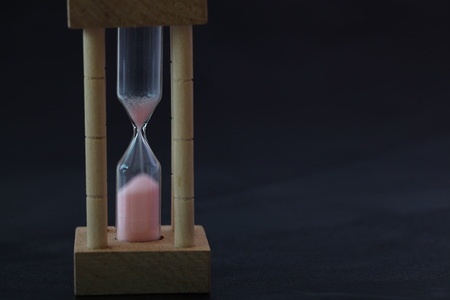 hourglass in a black background