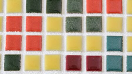 various color of small tiles pasting on the board
