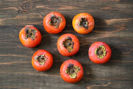 persimmons in a wooden backgroundの写真素材