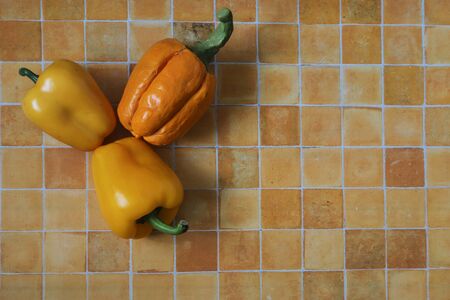 real and artificial paprikas on the tile boardの写真素材