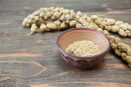 bunch of millet in a wooden backgroundの写真素材