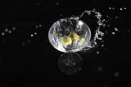 liquid splashing in the cocktail glassの写真素材