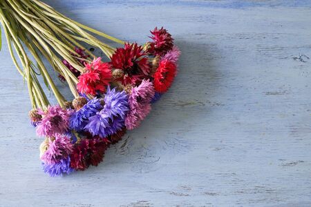 bouquet of cornflower in a wooden backgroundの写真素材