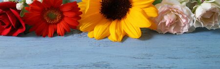 various kind of flowers in a wooden backgroundの写真素材